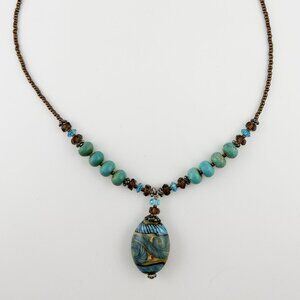 Vintage necklace with ornate glass bead pendant